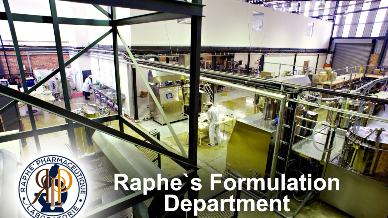 Interior view of Raphe's pharmaceutical formulation department with machinery and workers in white lab coats