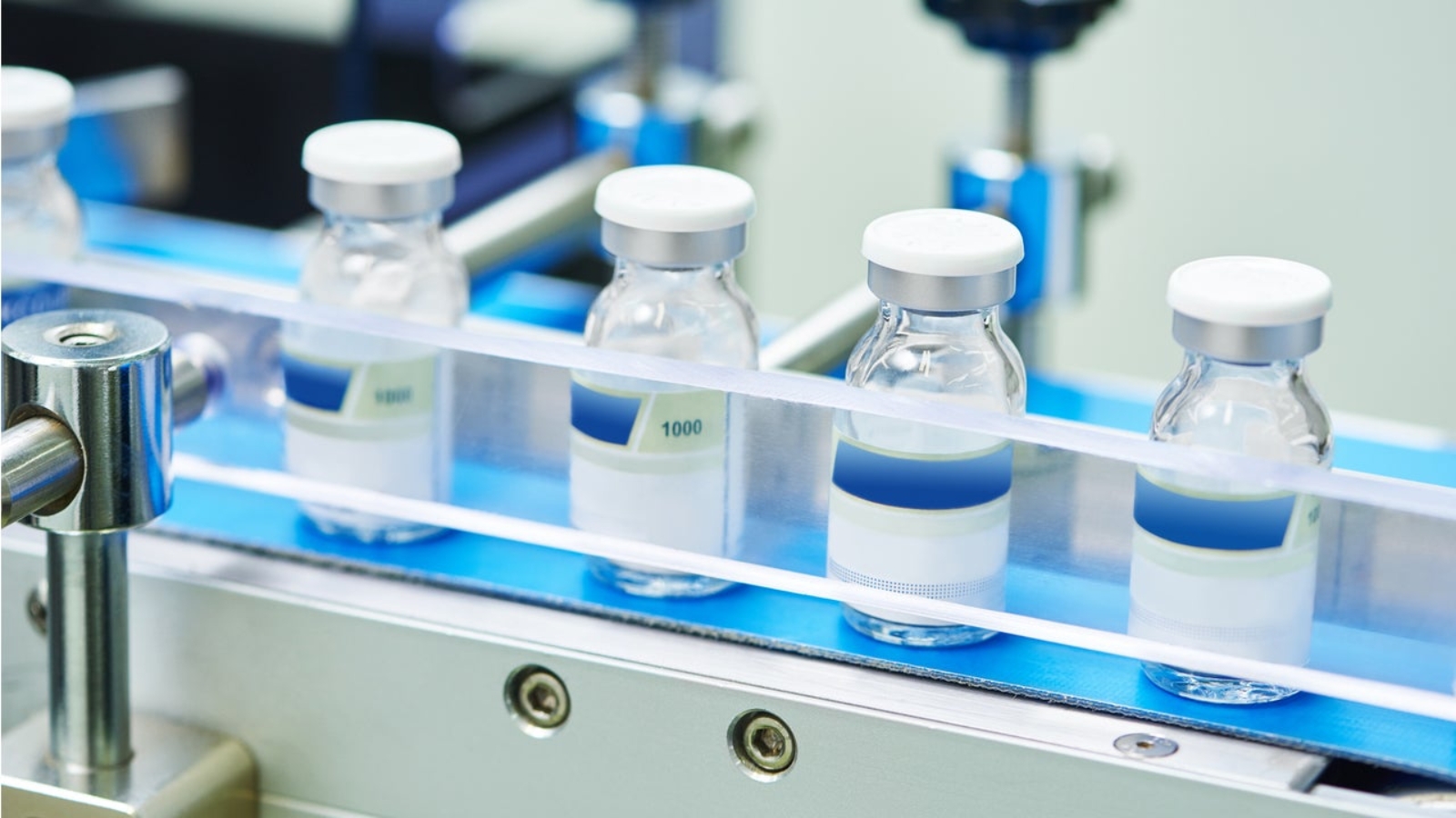 Vials on a production line in pharmaceutical manufacturing facility