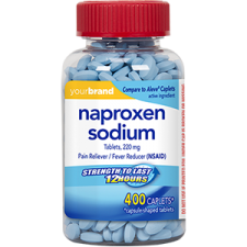 Bottle of naproxen sodium tablets with red cap and label showing pain relief medication