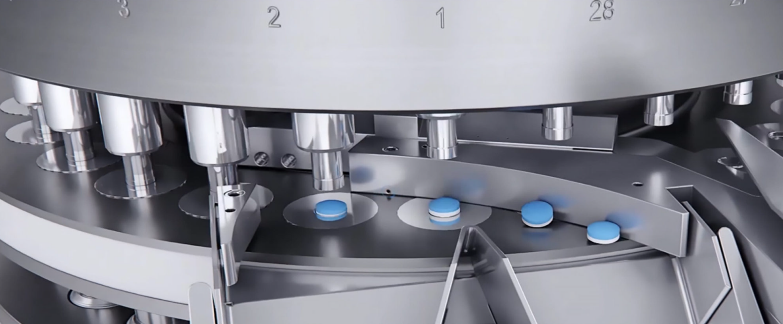 Automated pharmaceutical tablet pressing machine producing blue and white pills