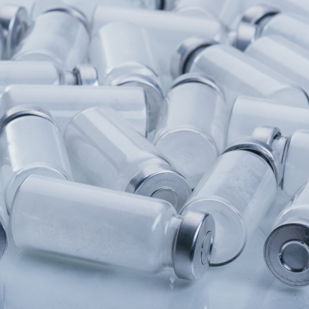Product image of Tirzepatide manufacturer vials scattered on a surface.